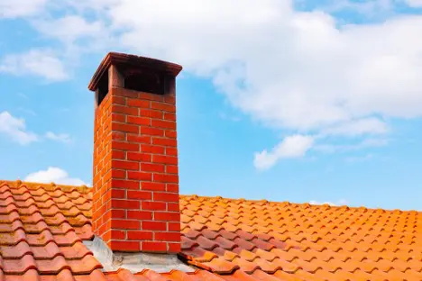 Brick chimney on a roof