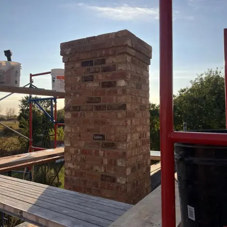 Brick chimney on a roof
